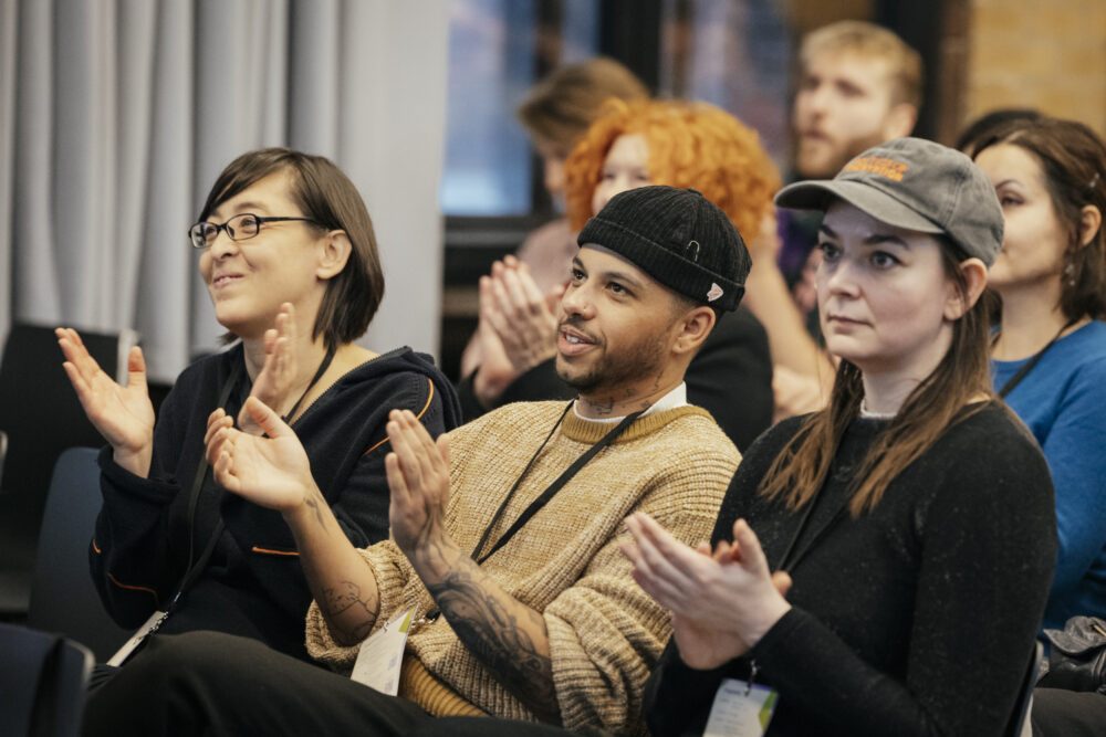 Applaudierende Personen bei der NxM Konferenz